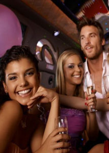 Image of three people celebrating in a party bus